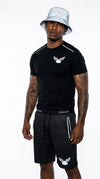 Model wearing iLLionaire Society Men's Reflective Shorts Set - Perforated Athletic T-Shirt and Matching Shorts with 3M Reflective Logo