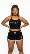 Model wearing iLLionaire Society Women's Black Reflective Shorts Set - 3M Reflective Two-Piece Streetwear.